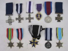 Eleven copies / reproduction metals to include Victoria Cross and Military Cross enclosed in