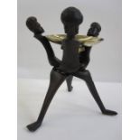 Carved hardwood stand of three warriors with brass bowl, possibly used for fruit, 32cm high