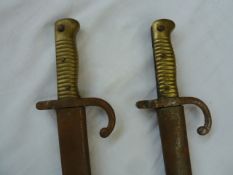 Two 19th century French bayonets with scabbards (rusty)Condition ReportSerial numbers on blades and