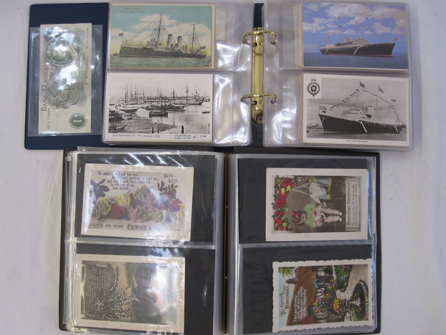 Two albums of mainly early to mid 20th century postcards, including Christmas and New Year street