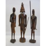Carved Tanzanian warrior with spear, 54cm high and a pair of male and female Tanzanian figures