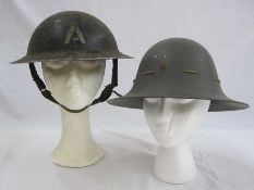 WWII Brodie style helmet used by the Ambulance Service together with WWII Civil Defence helmet