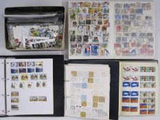 Three albums and a tin of GB, mostly of Queen Elizabeth II used stamps, one album of Jersey mint new