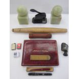 Green onyx book ends, a vintage cast iron paper letter embosser, red leather address and telephone