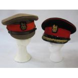 Four military caps belonging to Major Champion, Queen's Regiment, leather sword frog, Queen's