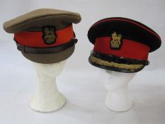 Four military caps belonging to Major Champion, Queen's Regiment, leather sword frog, Queen's