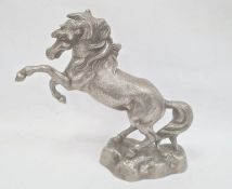 Cast metal model of rearing horse on rocky base, 33cm high