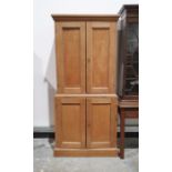 Oak cupboard with moulded cornice above two panelled doors enclosing shelves, the base with two