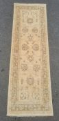 Modern Eastern-style cream ground runner with foliate decoration and border, 246cm x 80cm