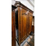 19th century French armoire with moulded cornice above two panelled doors enclosing hanging space