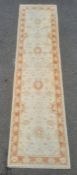 Modern cream ground runner with foliate decoration, peach ground border, 308cm x 80cm