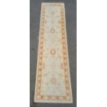 Modern cream ground runner with foliate decoration, peach ground border, 308cm x 80cm