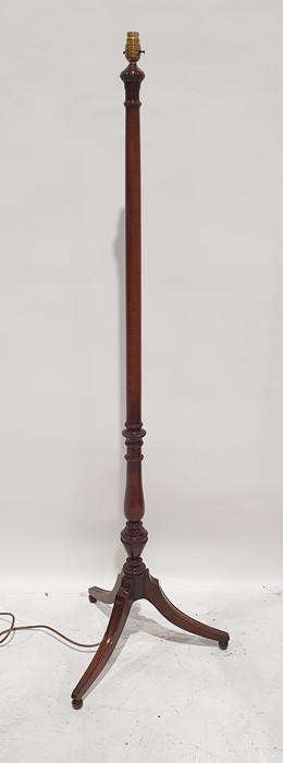 20th century mahogany standard lamp on swept and reeded supports to ball feet