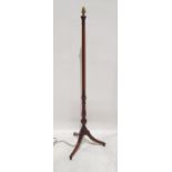 20th century mahogany standard lamp on swept and reeded supports to ball feet