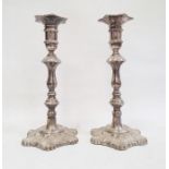 Pair of 1970's silver-mounted candlesticks with relief decoration, on quatrefoil-shaped bases and