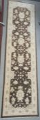 Modern Eastern-style brown ground rug with cream decoration, 303cm x 83cm