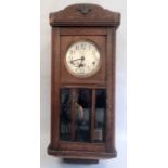 20th century oak wall clock with Arabic numerals to the dial, oak case