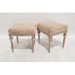 Pair of Swedish-style stools with cream upholstered overstuffed seats, on carved and fluted supports