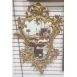 Possibly 19th century mirror, the shaped plate in gilt bronze rococo-style frame, 82cm x 49cm approx