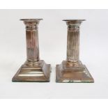 Pair of late 19th/early 20th century silver-mounted candlestick holders with beaded rims to fluted