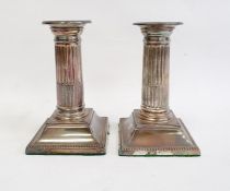 Pair of late 19th/early 20th century silver-mounted candlestick holders with beaded rims to fluted