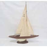 Varnished and painted wood model yacht with canvas sails and the associated wooden stand, 102cm high