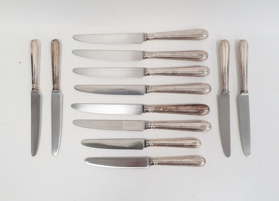 Six modern silver-handled table knives and six dessert knives with filled handles