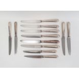 Six modern silver-handled table knives and six dessert knives with filled handles