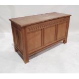 20th century oak coffer, rectangular top with moulded edge, three panels to the front, shaped