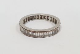 Diamond eternity ring set with 36 baguette-cut diamonds, channel set (one stone missing), finger