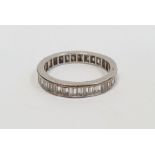 Diamond eternity ring set with 36 baguette-cut diamonds, channel set (one stone missing), finger