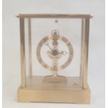 Modern mantel clock in four-sided glass and brass case, with Roman numerals