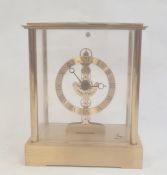 Modern mantel clock in four-sided glass and brass case, with Roman numerals