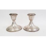 A pair of Gorham sterling cement filled squat candlesticks, 10cm high (2)