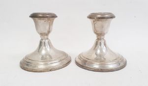 A pair of Gorham sterling cement filled squat candlesticks, 10cm high (2)