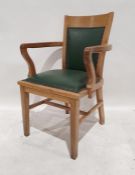 20th century oak armchair with green vinyl seat and back, on square section legs, tapering supports