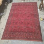 Eastern-style rug, red ground with repeating pattern decoration, stepped border, 298cm x 204cm