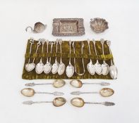 A set of Asian silver coloured metal teaspoons and sugar nips, with monkey, elephant  and animal