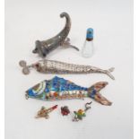A silver coloured metal and enamel articulated fish in blue, white and orange, another silver