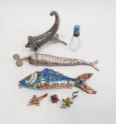 A silver coloured metal and enamel articulated fish in blue, white and orange, another silver