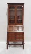 20th century oak bureau bookcase, the moulded pediment above two astragal glazed doors enclosing