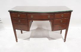 20th century bowfront dressing table of seven assorted drawers, on square section fluted tapering