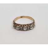 Gold carved head ring set with three graduated mixed cut diamonds interspersed by two pairs of