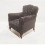 Late Victorian armchair with black loose covers, on turned front legs to brown china castors