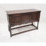 20th century oak sideboard with two linenfold decorated doors, on turned supports and stretchered