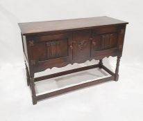 20th century oak sideboard with two linenfold decorated doors, on turned supports and stretchered