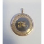 19th century gold-coloured memorial pendant of circular form with gilt metal initials surrounded