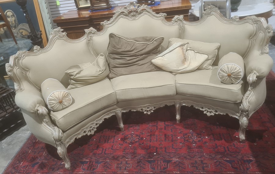 Modern French-style beige painted and upholstered curved three-seat sofa and cushions Condition