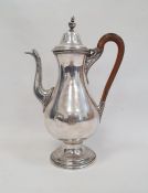 A silver plated coffee pot, wooden handle on a circular base, unmarked, etched V EL to base, 29cm