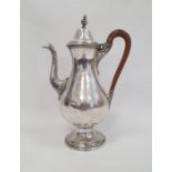 A silver plated coffee pot, wooden handle on a circular base, unmarked, etched V EL to base, 29cm